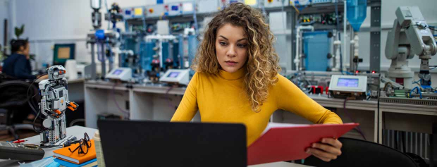 Student using laptop in mechanical lab